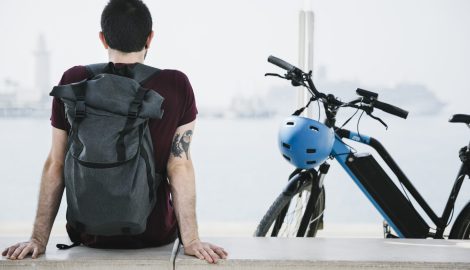 back-view-man-sitting-his-e-bike