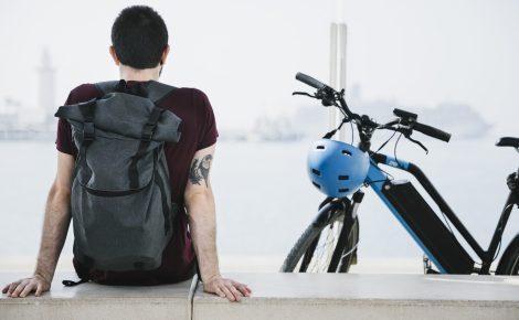 back-view-man-sitting-his-e-bike